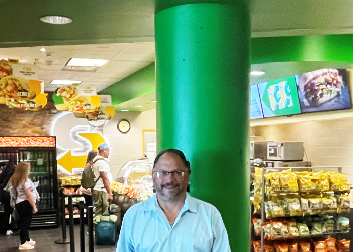 Manny Perez in front of his Terminal 2 Subway shop